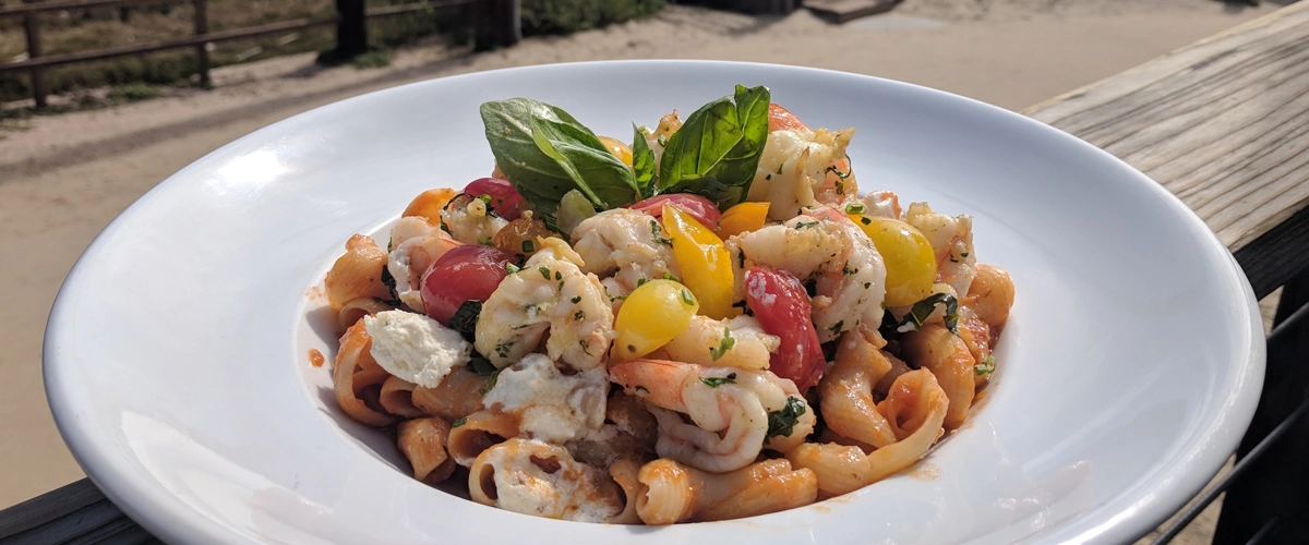 Shrimp pasta with tomatoes and fresh basil.